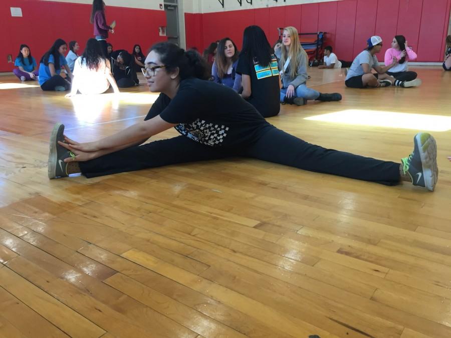 Senior Wren Murray warms up prior to participating in her physical education class