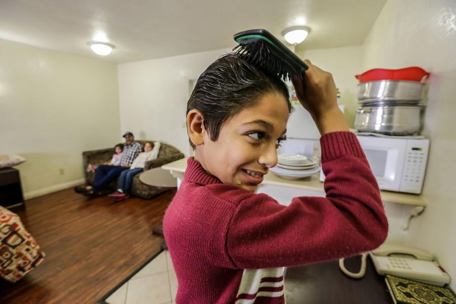 Eleven-year-old Omran Wawieh, right, a refugee from Syria, is staying with parents and siblings at a motel in Pomona, Calif., on Tuesday, Nov. 17, 2015.