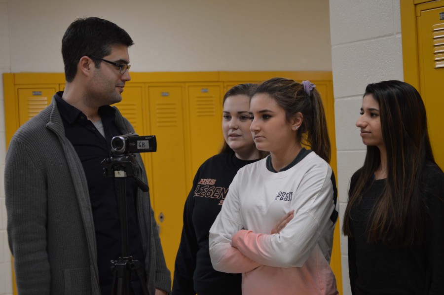 Art teacher Michael Bober assists, from left to right, senior Becca Delaney, freshman Lenah Chedid, and senior Serina Patel with a film project. Bober was recently named the HHS Teacher of the Year.