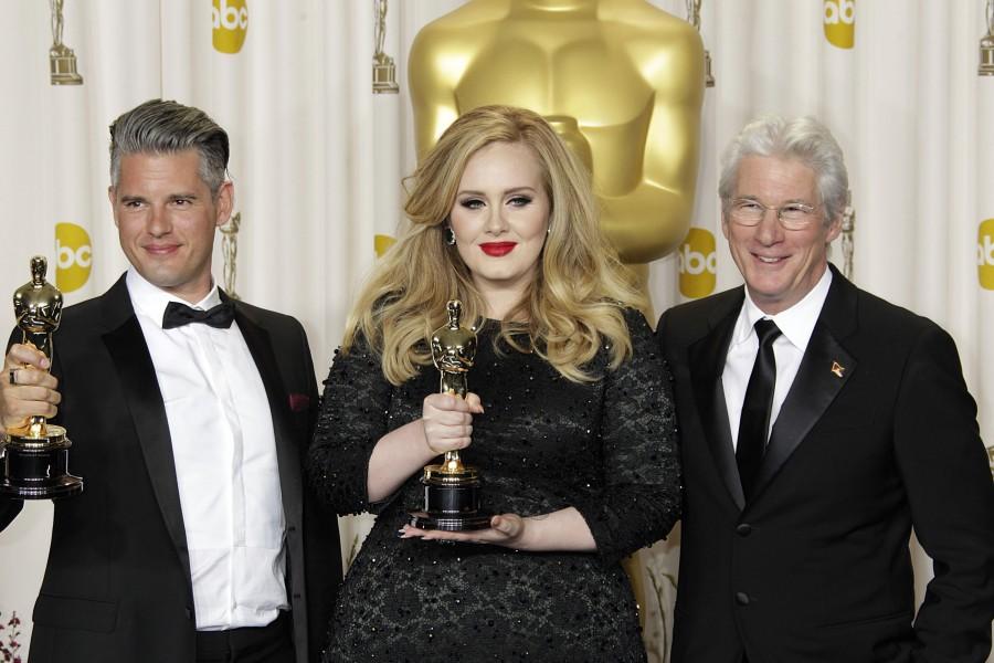 Richard Gere, right, accompanies Adele Adkins and Paul Epworth as they hold their Oscar for Achievement in Music (Original Song) for the film "Skyfall"; in the press room during the 85th annual Academy Awards held at the at the Dolby Theatre at Hollywood's Highland Center in Los Angeles, California, Sunday, February 24, 2013. 