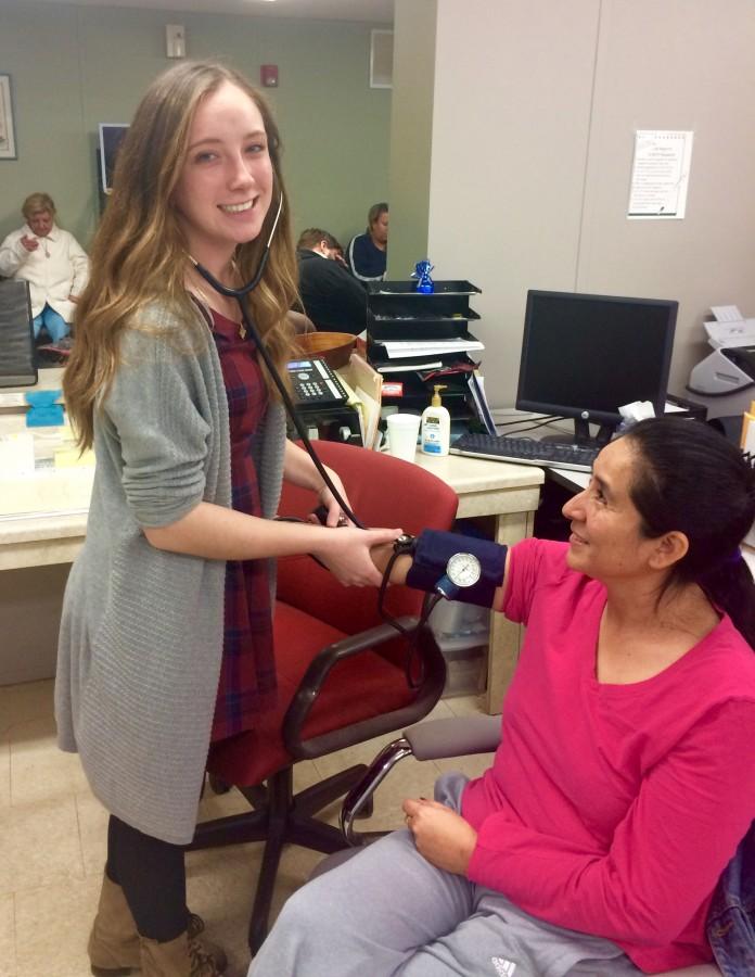 Senior Natalia Roszkowska checks vitals as a volunteer at Zarephath Health Center.