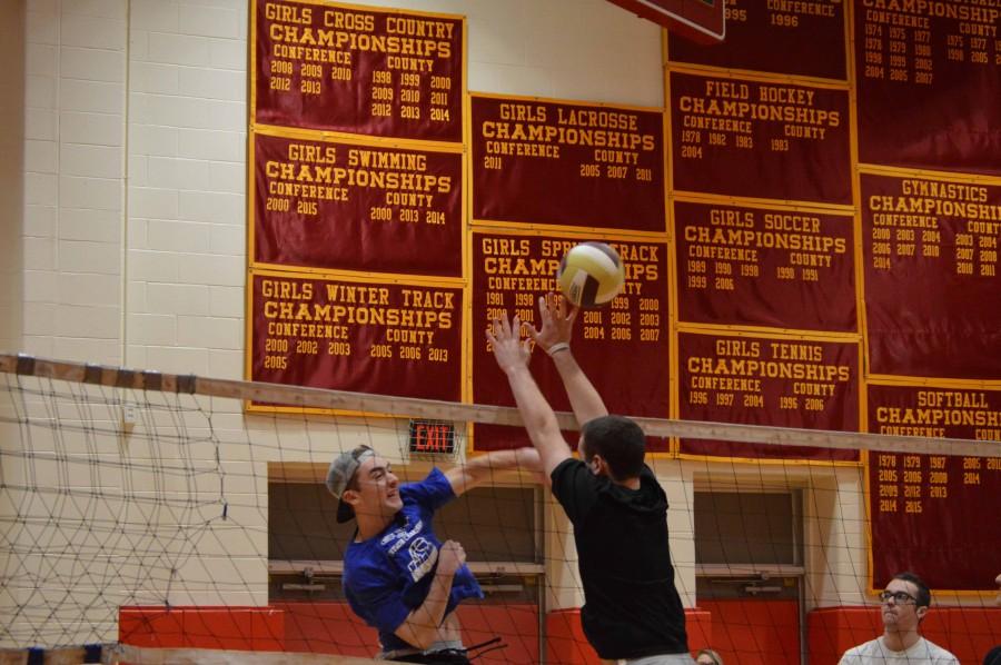 Senior Shaun Consentino attempts a spike while senior Zach Maggio looks to block the shot  during a highly contested match in power volleyball.