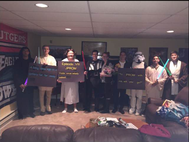 From left to right: Jay Raje, Carter Altman, Jordan Kang, Danny Kozimbo, Ashley Gill, Thomas Pennacchio, Anand Patel, Viv Honwad, and Liam Jurkowich display the Star Wars theme prom proposal. May the force be with you on prom night.