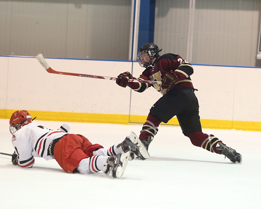 Junior Alex MacPhee sends the puck into enemy territory with authority.