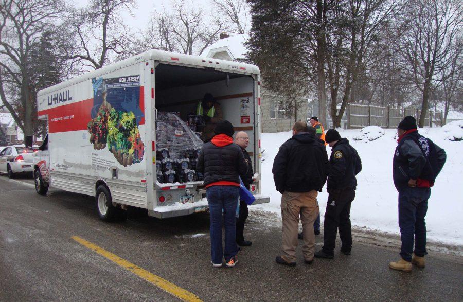 United Auto Workers union volunteers distribute bottled water, filters and informational fliers in the Mott Park neighborhood of Flint, Mich., a city of about 100,000 whose residents have recently been advised not to drink unfiltered tap water due to lead contamination. 