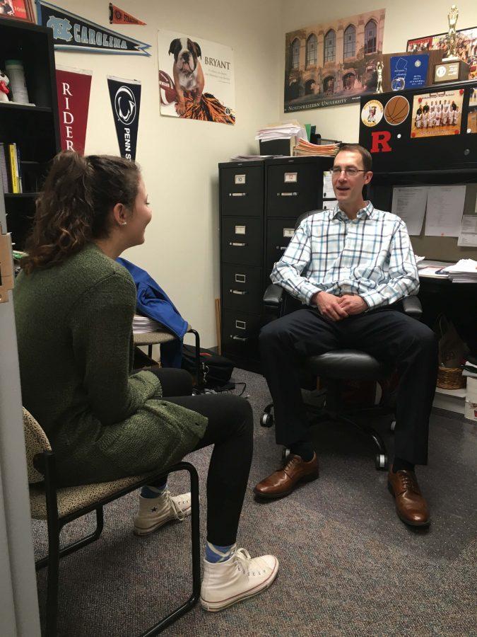 Guidance counselor Ian Progin working with one of his students, junior Lisa Myers.