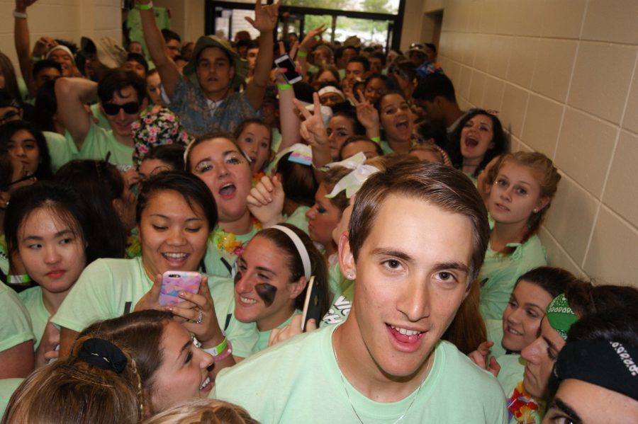 Senior Alex Romanoski leads the Sightseers into the gym for a successful Spirit Night.