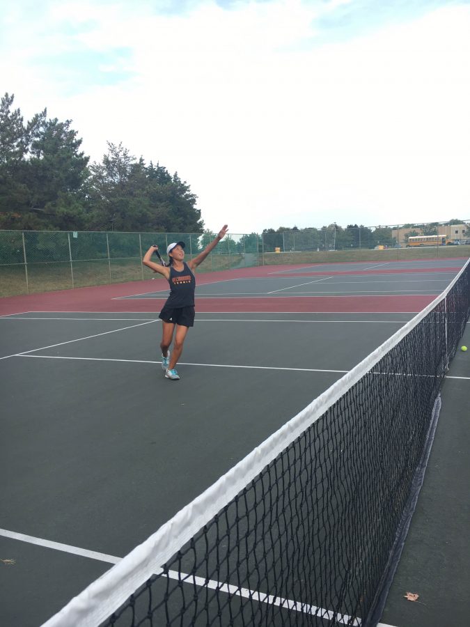 Sophomore Hannah Kim prepares to end a point with an overhead smash.