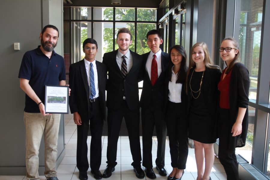 Senior Rebecca Della Croce, second from right, poses after presenting her final research project at Rutgers.