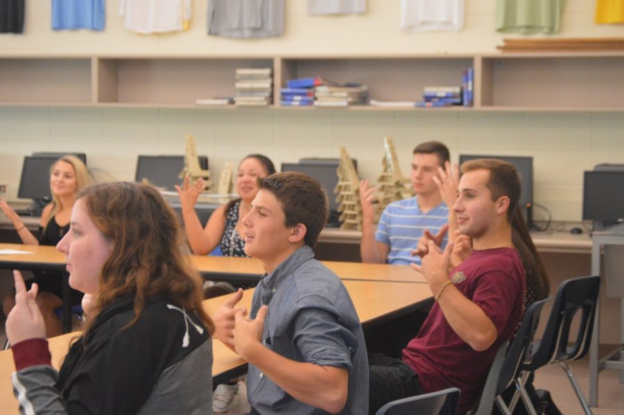 Senior Michael Cavallo, far right, signs alongside his classmates in his tenth period sign language class.