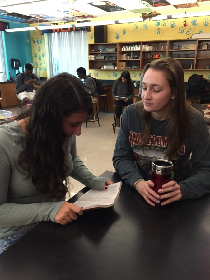 Juniors Caroline Pabst and Marissa Osofsky discuss the summer reading assignment in homeroom last week.