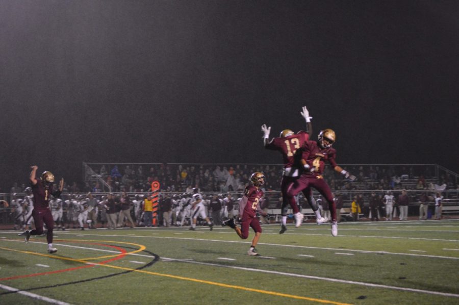 Juniors Charles Amankwaa (13) and Noah Quick (4) celebrate a game-changing play in the team's 27-13 win over Phillipsburg.