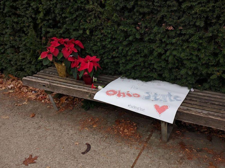 Pointsettias and a sign left outside of Watts Hall in dedication of the 2016 Ohio State University attack.