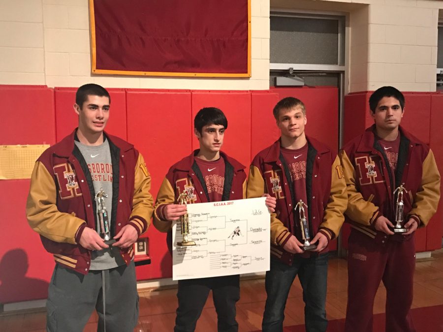 From left to right, juniors Mike Dinardi, Anthony Donnadio, and Kevin Faulkner pose with sophomore Emilio Guerrero Nieto and some hard-earned hardware after the East Brunswick Invitational. The team finished in third place.