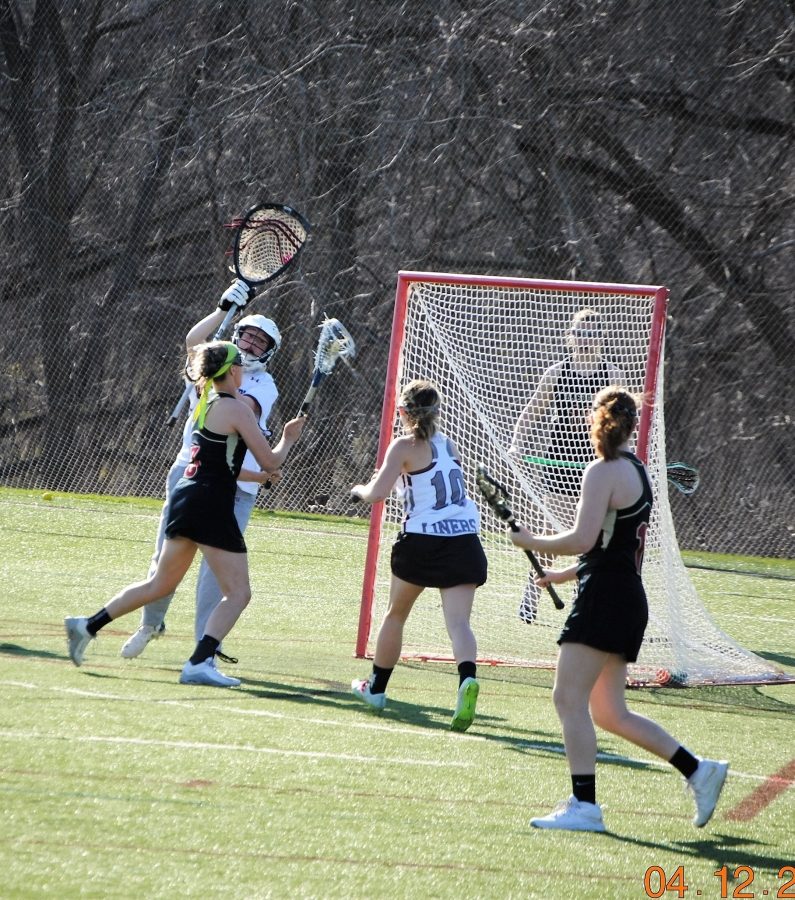 Junior Olivia Johnsen attempts to put the ball in the net. Johnsen was instrumental in the team's first victory.