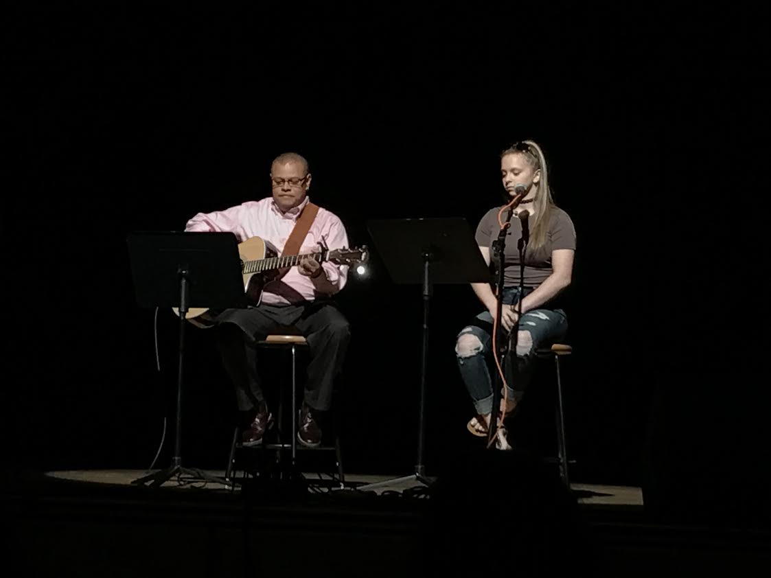 Student assistance counselor Gil Pilarte and junior Stella Pashaian performing a Bob Dylan tune at Unplugged.