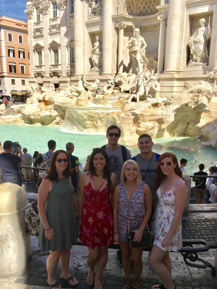 Italian teacher Jennie Crea poses in front of Rome's Trevi Fountain with her students.