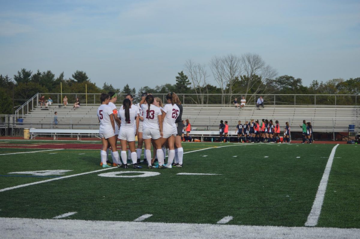 The second half starters huddle before beginning the next half during the team's 3-0 loss to Pingry. 