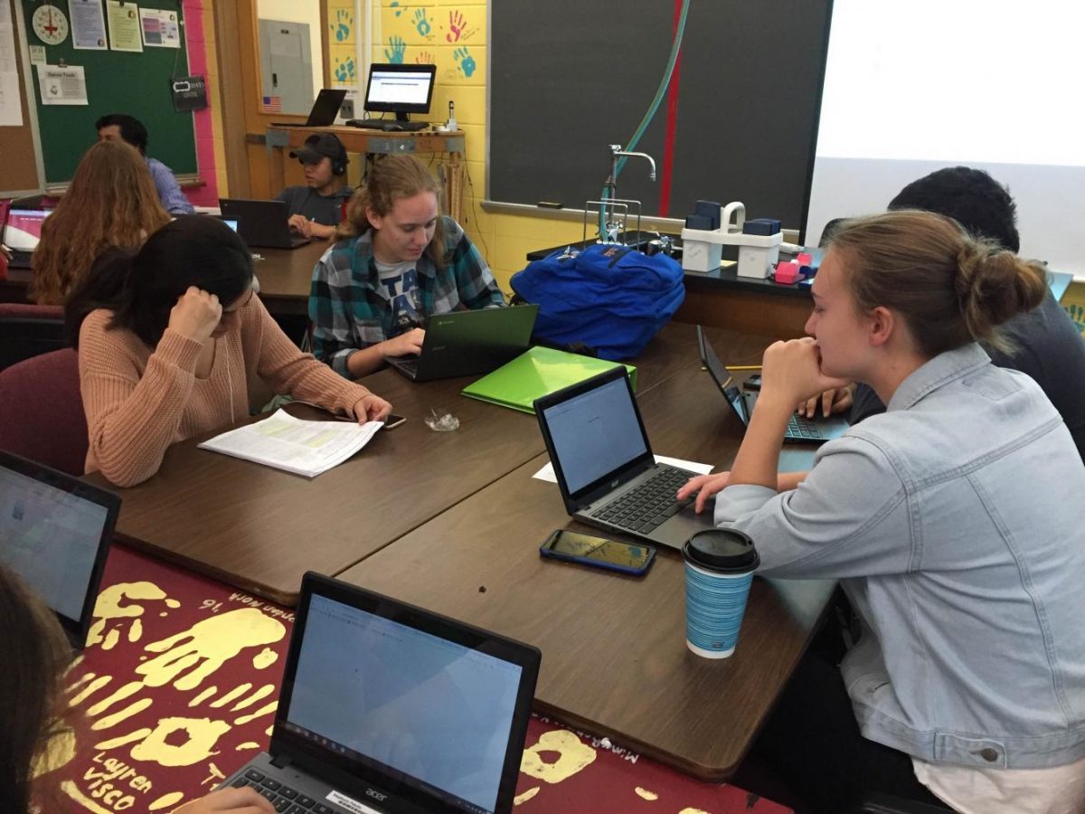 Seniors in Tessa Mazzeo's homeroom work their way through a discussion of this year's summer reads.