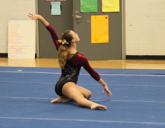 Gymnast Clare Hanlon flawlessly finishes her floor routine. 