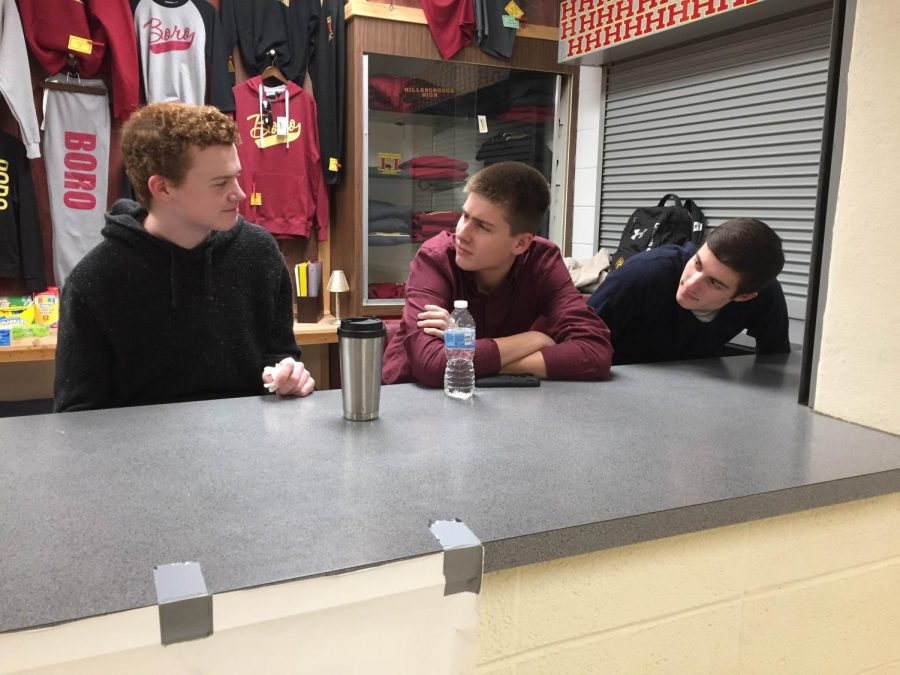 Senior Class Cabinet members Colin Downes, Michael Shokoff, and Michael Jeney meet in the school store to discuss Spirit Night. 