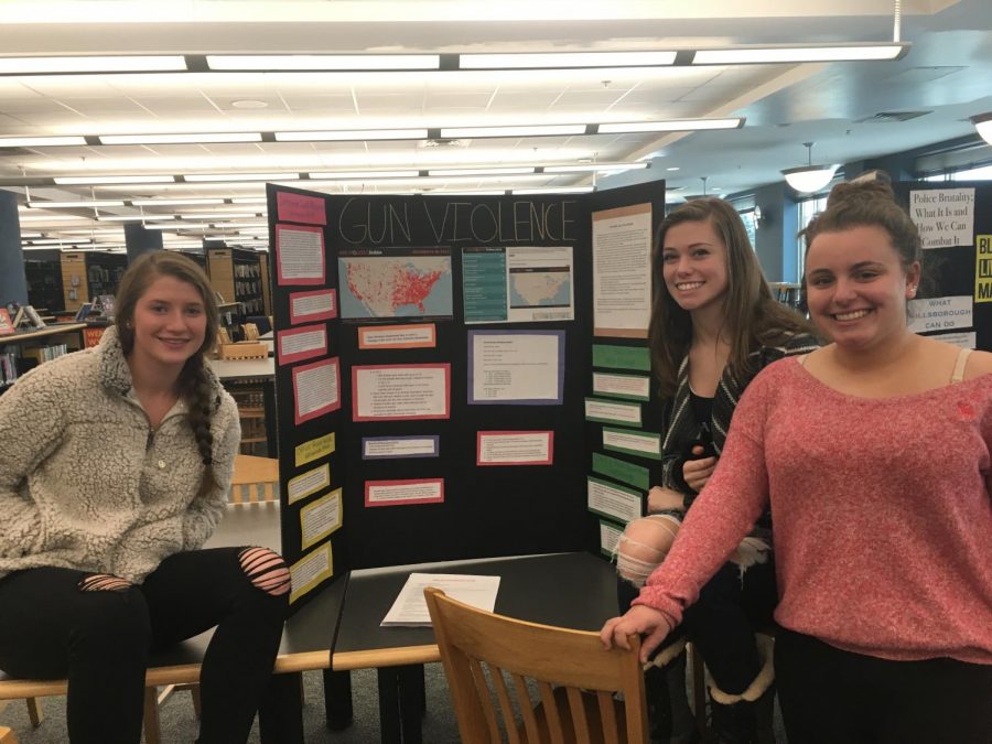 Seniors Olivia Buckman, Erica Volpe, and Megan Hollasch pose next to their project.