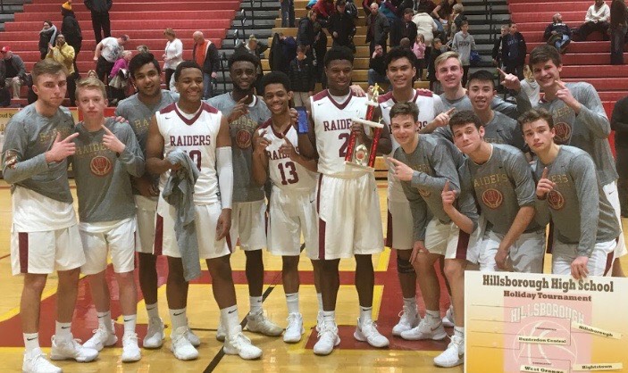 The boys celebrate winning the title at the Raiders Holiday Classic.