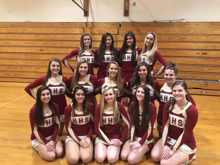 The winter varsity cheer team poses before cheering for the first time this winter.