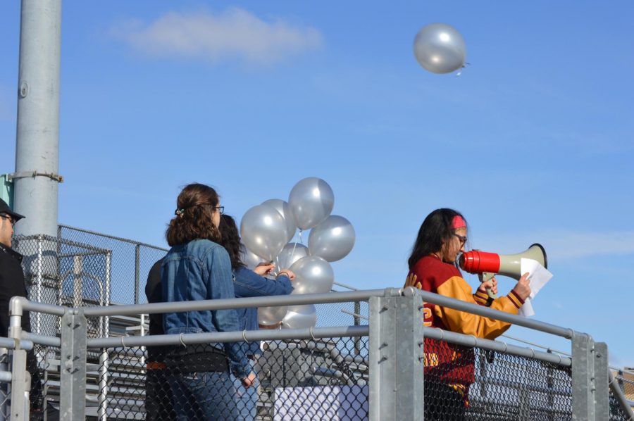 Students release 17 silver balloons in honor of the 17 victims of the Parkland shooting. 