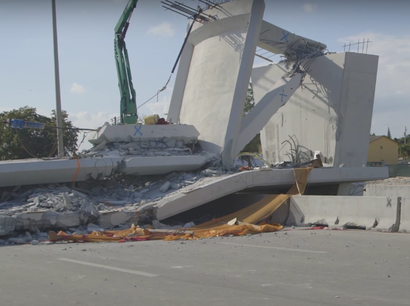 The bridge collapsed directly onto a major roadway, killing two.