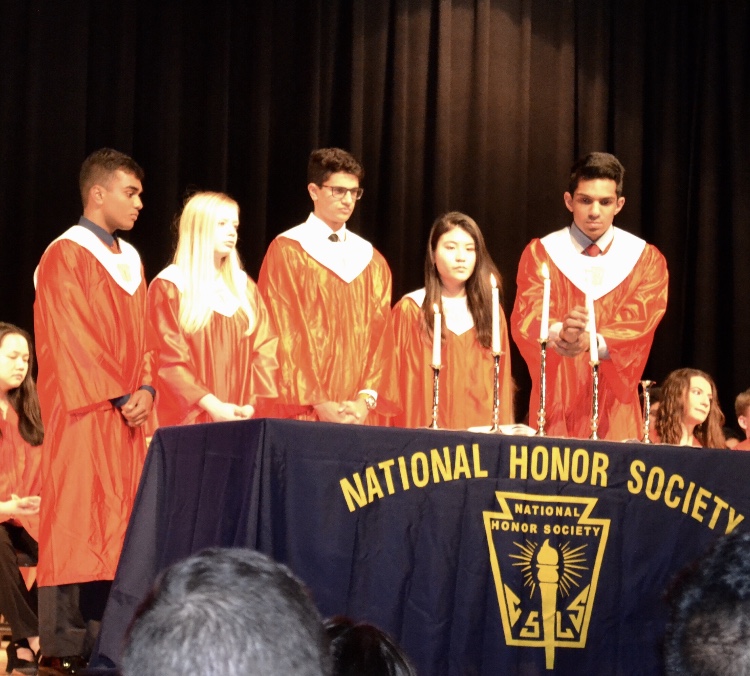 From left to right, seniors Rohil Chada, Kaley Murday, Karan Mahesh, Catherine Nguyen, and Rakesh Senthilvelan light the candles representing the pillars of the National Honor Society. 