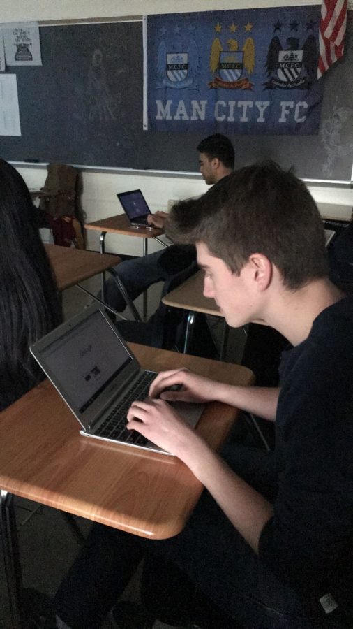 Senior Michael Atlas struggles with a loaner Chromebook in his AP English Literature class.