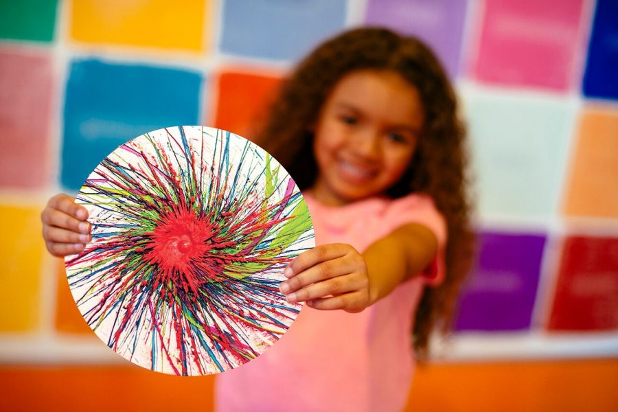 A visitor to the Crayola Experience shows off her spin art project!