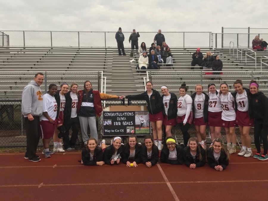 Senior Olivia Johnsen celebrates with her team following her 100th goal.