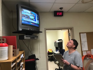 Vice President Thomas Kotarsky views the Weather Channel prior to making the executive decision on whether or not students go outside for gym. 