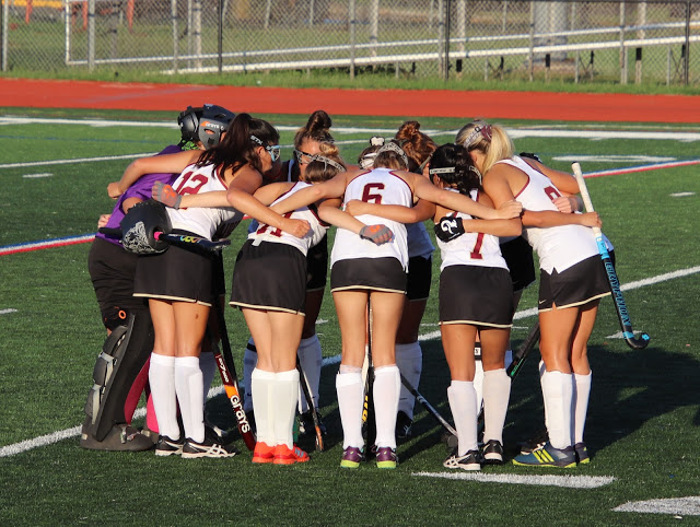 The field hockey team discusses the game plan right before the start of their first contest.