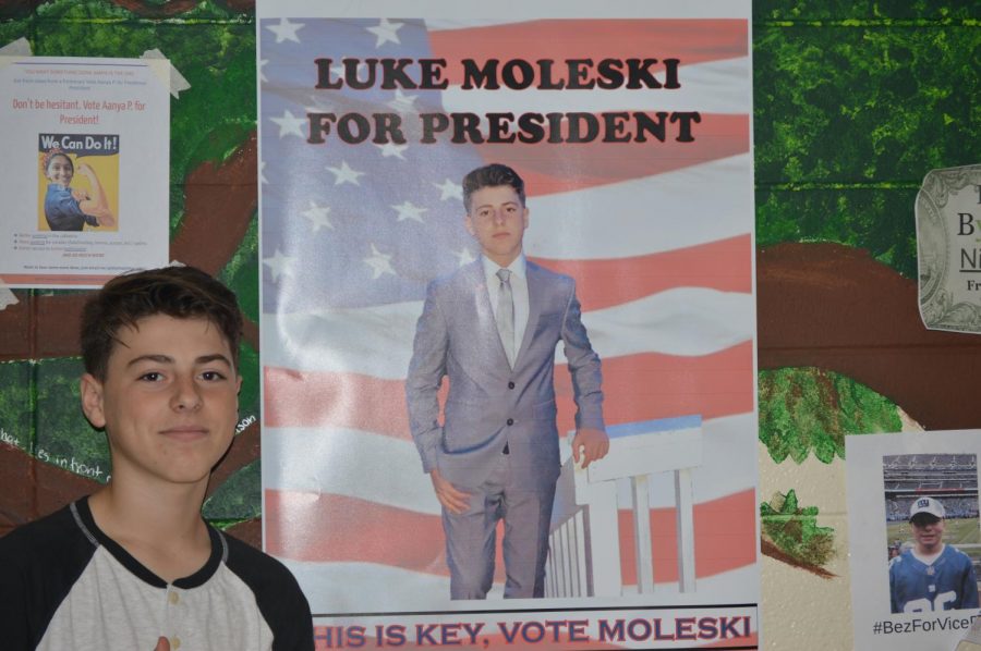 Freshman Luke Moleski stands in front of one of his campaign posters.