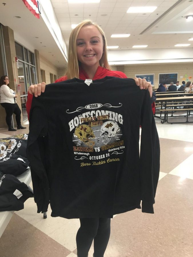 Sophomore Heather Suraci holds the 2018 homecoming shirt.