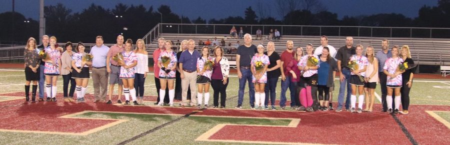 The seniors lined up before the game with their parents on Senior Night.