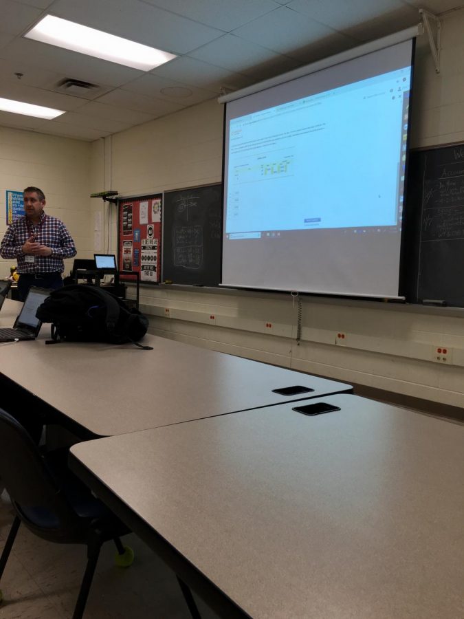 Paul Goldstein teaches his period 10 Accounting I class about checkbook entries. 