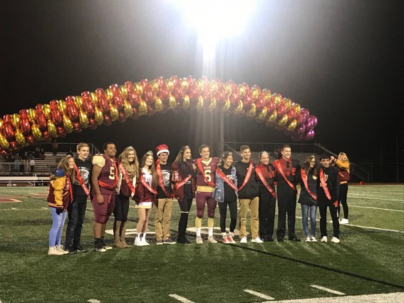 The 2018 Homecoming Court poses at the Friday night game prior to the Saturday dance.