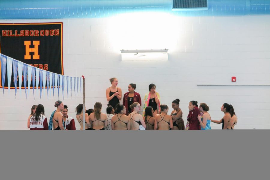 Seniors Jordan McChesney, Sankya Parvatrao, and Nicole Zou give the team a speech before the meet against Mount Saint Mary on Dec. 6..