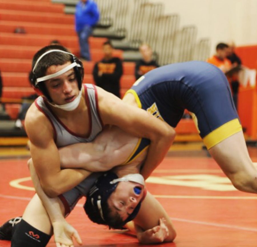 Junior Christian Kruskall attempts to gain an advantage over his opponent in a match from last season. Kruskall and the team will open the season Dec. 19.