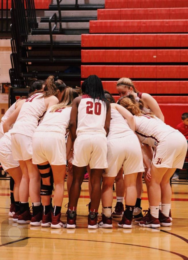 The girls basketball team discusses their game plan before the tip-off. 