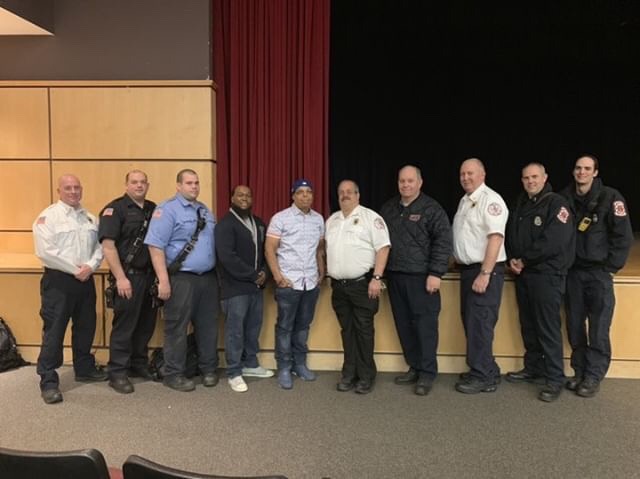 Alvaro Llanos and Shawn Simons, who presented "After the Fire", stand alongside members of the Hillsborough Fire Department.