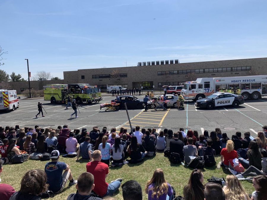 Students gather to observe the chilling staged accident scene. 