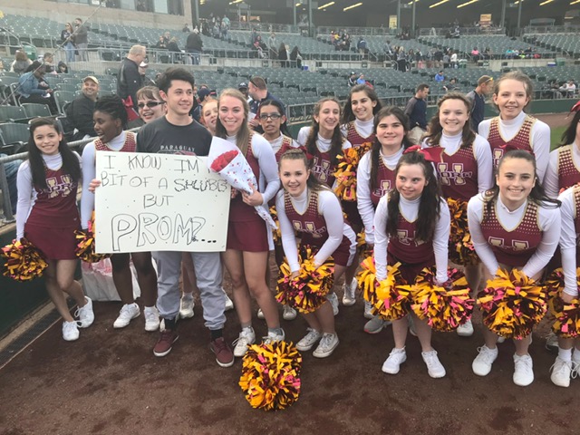 The Raiders pose after their performance at the Patriots game, which also had a "promposal" for captain Sarah Friedman.