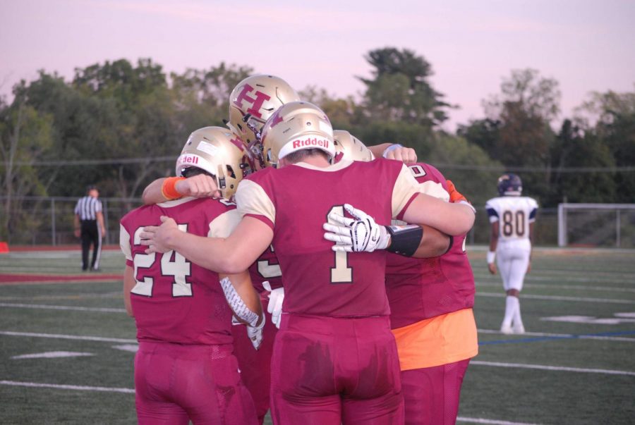 Junior Sean Levonaitis and senior Tom Ramsey huddle before their game against Franklin Warriors. 