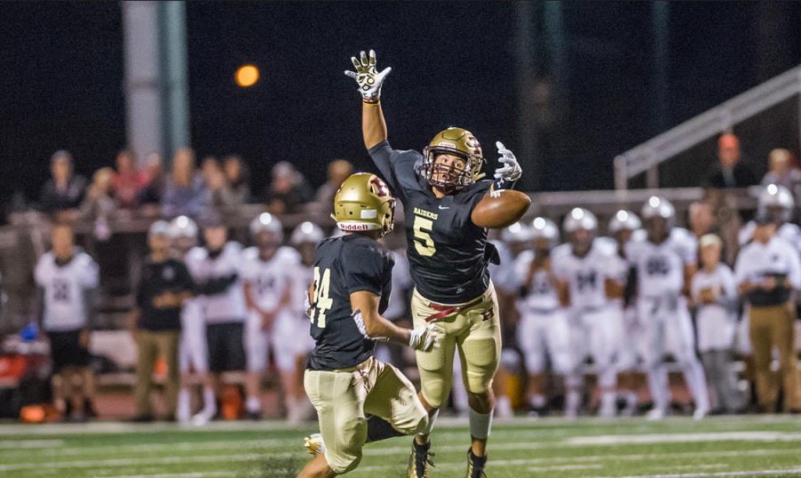 Senior Thomas Schultz (right and junior Sean Levonaitis make an attempt to intercept the ball during their game against the Panthers. The Raiders won 13-12.