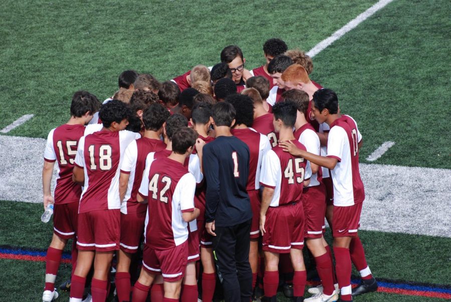 The boys soccer team takes instructions from head coach Eric Puma prior to a recent contest.